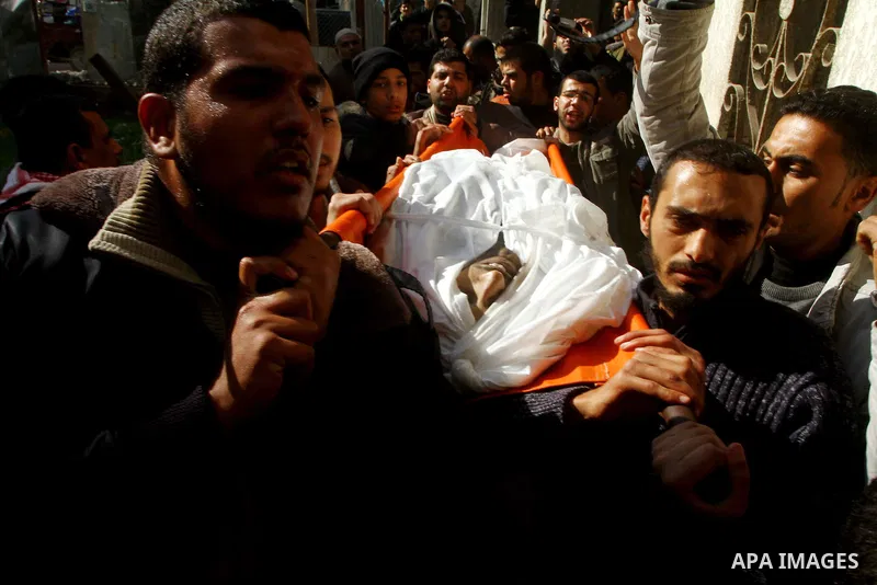 Palestinian mourners carry the body of Abdallah al-Telbani, 22-years-old, during his funeral in Gaza City on December 28, 2011, after he was killed following an Israeli airstrike. Photo by Ashraf Amra