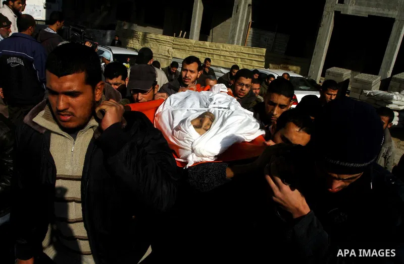 Palestinian mourners carry the body of Abdallah al-Telbani, 22-years-old, during his funeral in Gaza City on December 28, 2011, after he was killed following an Israeli airstrike. Photo by Ashraf Amra