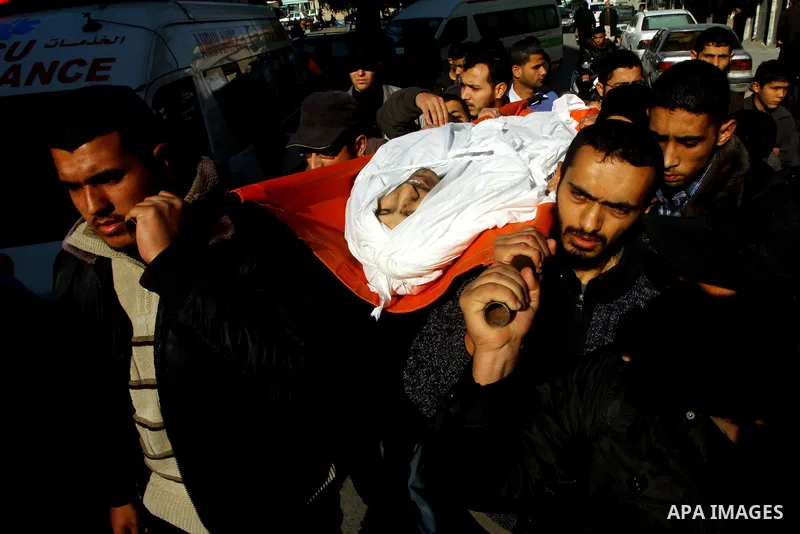 Palestinian mourners carry the body of Abdallah al-Telbani, 22-years-old, during his funeral in Gaza City on December 28, 2011, after he was killed following an Israeli airstrike. Photo by Ashraf Amra