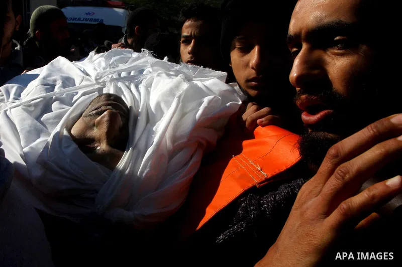 Palestinian mourners carry the body of Abdallah al-Telbani, 22-years-old, during his funeral in Gaza City on December 28, 2011, after he was killed following an Israeli airstrike. Photo by Ashraf Amra