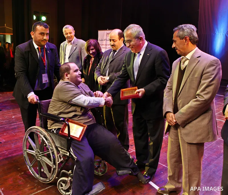 Palestinian Prime Minister, Salam Fayyad, attends at the opening of the second Palestine Festival of creativity for people with disabilities, in the West Bank city of Ramallah, on Dec. 28, 2011. Photo by Mustafa Abu Daye...
