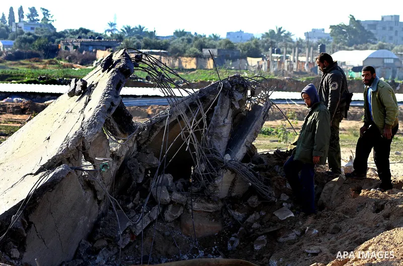 Palestinians survey an Islamic Jihad training camp damaged by an Israeli air strike in Gaza December 29, 2011. The Israeli army confirmed that it targeted two sites in Gaza, including the training camp, and added that th...