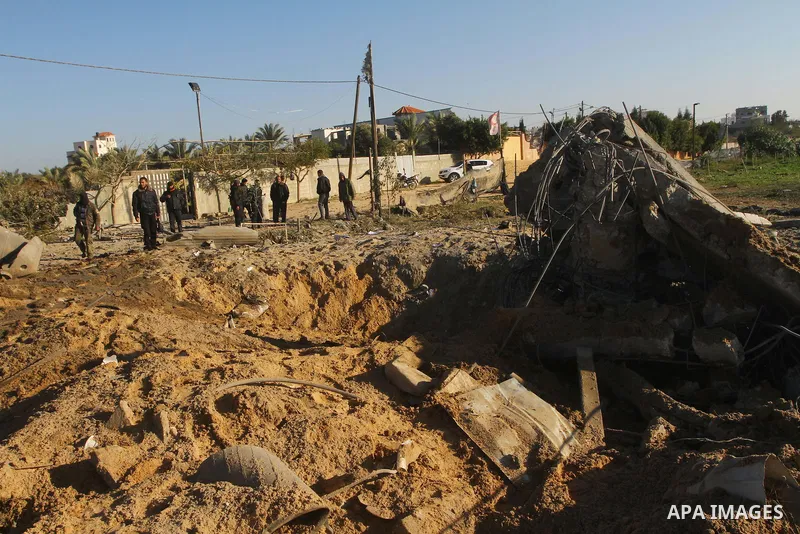 Palestinians survey an Islamic Jihad training camp damaged by an Israeli air strike in Gaza December 29, 2011. The Israeli army confirmed that it targeted two sites in Gaza, including the training camp, and added that th...