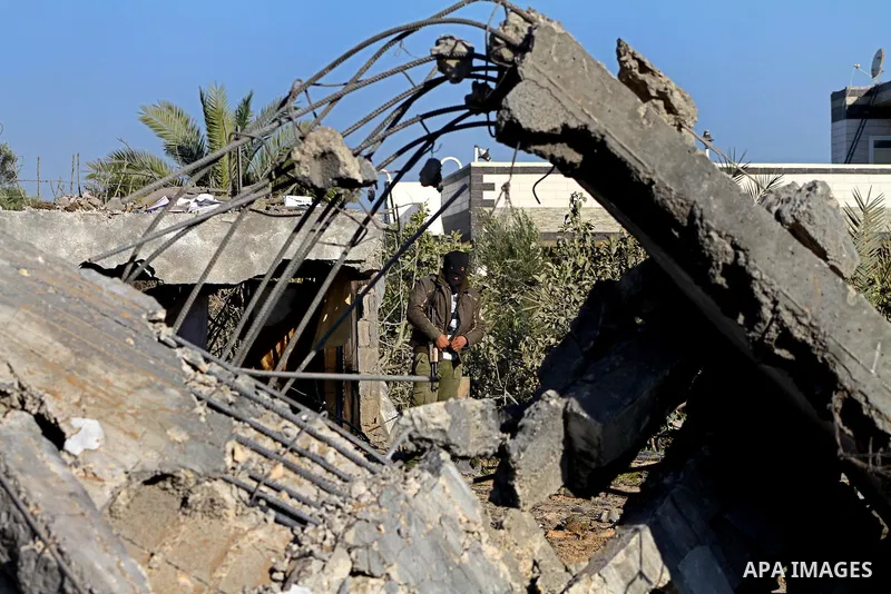 Palestinians survey an Islamic Jihad training camp damaged by an Israeli air strike in Gaza December 29, 2011. The Israeli army confirmed that it targeted two sites in Gaza, including the training camp, and added that th...