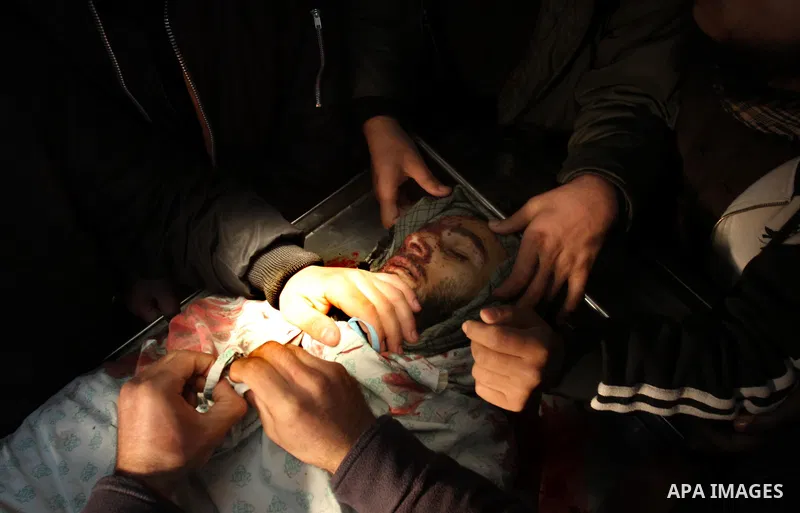 Palestinians look at the body of militant Momen Abu Daf during his funeral at a mosque in Gaza City December 30, 2011. Israel killed the leader of an al Qaeda-inspired faction in the Gaza Strip on Friday, accusing him of...