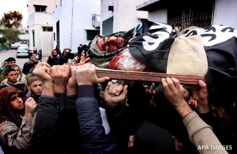 Palestinians carry the body of militant Momen Abu Daf during his funeral in Gaza City December 30, 2011. Israel killed the leader of an al Qaeda-inspired faction in the Gaza Strip on Friday, accusing him of involvement i...