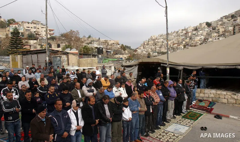 Palestinian Muslims attend Friday prayers at a street in the neighbourhood of shiek Jarah , in East Jerusalem on Dec 30,2011. Israel limited access to Jerusalem's Al-Aqsa mosque compound for fear of violence on the Musli...