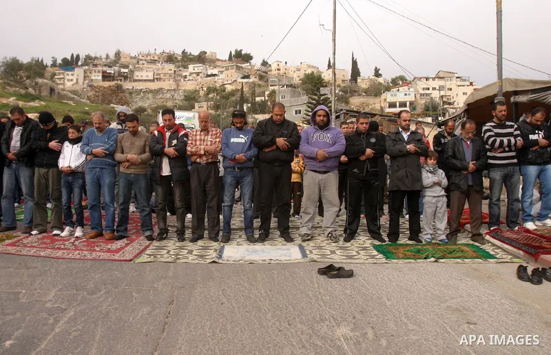 Palestinian Muslims attend Friday prayers at a street in the neighbourhood of shiek Jarah , in East Jerusalem on Dec 30,2011. Israel limited access to Jerusalem's Al-Aqsa mosque compound for fear of violence on the Musli...