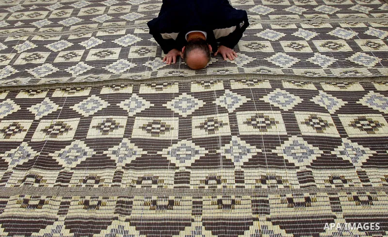 Palestinian Muslims attend Friday prayers at a street in the neighbourhood of shiek Jarah , in East Jerusalem on Dec 30,2011. Israel limited access to Jerusalem's Al-Aqsa mosque compound for fear of violence on the Musli...