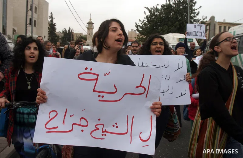 Palestinian arab residents of east Jerusalem, Israelis and foreign peace activists hold banners during a protest in the east Jerusalem neighborhood of Sheikh Jarrah, Dec 30, 2011. Photo by Mahfouz Abu Turk