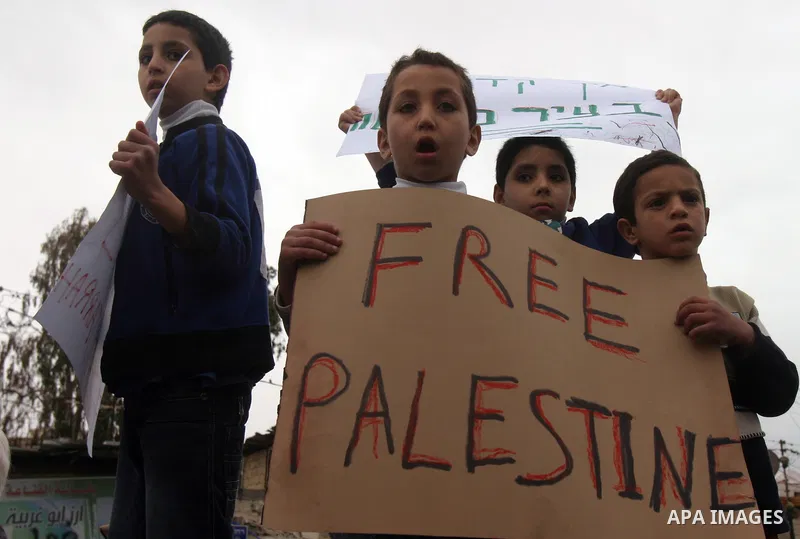 Palestinian arab residents of east Jerusalem, Israelis and foreign peace activists hold banners during a protest in the east Jerusalem neighborhood of Sheikh Jarrah, Dec 30, 2011. Photo by Mahfouz Abu Turk