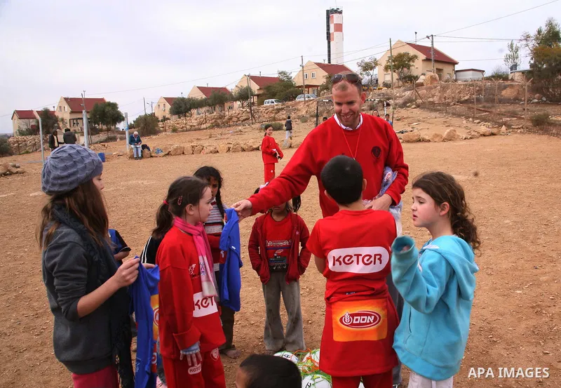 Israeli children from Kibbutz Harel (blue jerseys) play football with Palestinian children in the Umm al-Kheir village, near the West Bank city of Hebron, on December 30, 2011. Photo by Mamoun Wazwaz