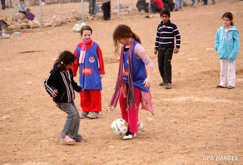 Israeli children from Kibbutz Harel (blue jerseys) play football with Palestinian children in the Umm al-Kheir village, near the West Bank city of Hebron, on December 30, 2011. Photo by Mamoun Wazwaz