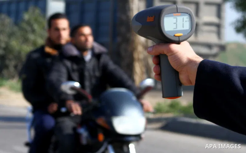 A Palestinian policeman uses for the first time a speed radar, in Gaza City, on Jan 03, 2011. The speed limit inside Gaza is 50 km/h.. Photo by Ashraf Amra