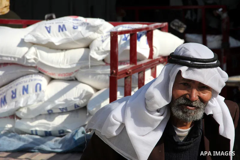 Palestinians collect food aid from the United Nations Relief and Works Agency (UNRWA) in the Rafah refugee camp, southern Gaza Strip, on Jan 04, 2012. Photo by Hatem Omar