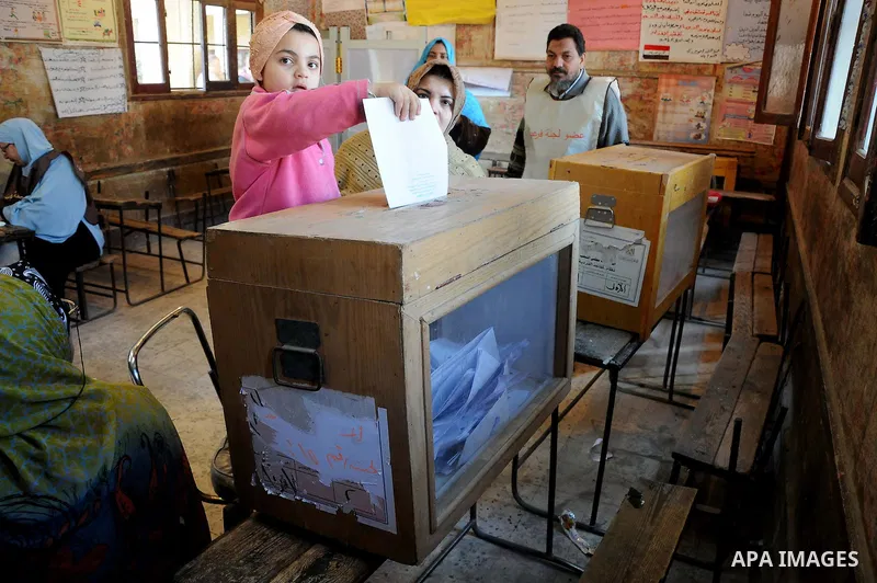 An Egyptian woman casts his vote at a polling center during the second day of the third round of the elections for Egypt's parliament, in Egypt, Wednesday, Jan. 4, 2012. Egyptians are voting in the final round of electio...
