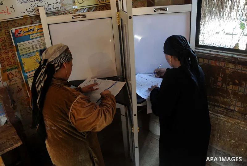 An Egyptian woman casts his vote at a polling center during the second day of the third round of the elections for Egypt's parliament, in Egypt, Wednesday, Jan. 4, 2012. Egyptians are voting in the final round of electio...