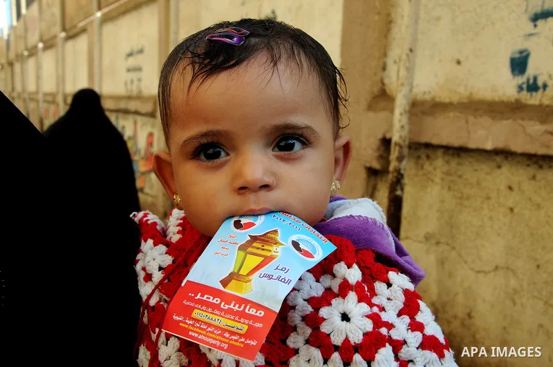 Egyptians arrive at a polling station to cast their votes during the second day of the third round of the elections for Egypt's parliament, in Egypt, Wednesday, Jan. 4, 2012. Egyptians are voting in the final round of el...