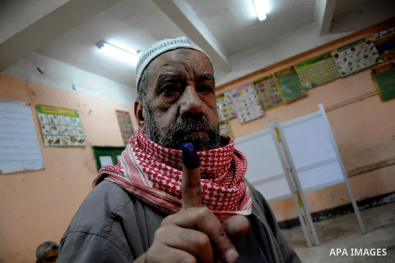 An Egyptian man shows her ink marked finger after casting her vote during the second day of the third round of the elections for Egypt's parliament, in Egypt, Wednesday, Jan. 4, 2012. Egyptians are voting in the final ro...