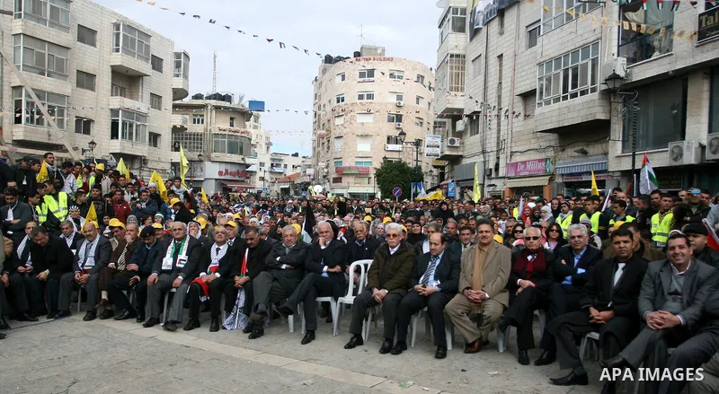 A Palestinians take part during a celebration to mark the 47th anniversary of the Fatah political movement, in the West Bank city of Ramallah, Wednesday, Jan. 4, 2012. Photo by Issam Rimawi