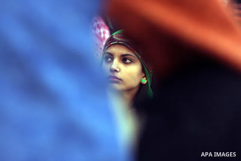 A Palestinian woman take part during a celebration to mark the 47th anniversary of the Fatah political movement, in the West Bank city of Ramallah, Wednesday, Jan. 4, 2012. Photo by Issam Rimawi
