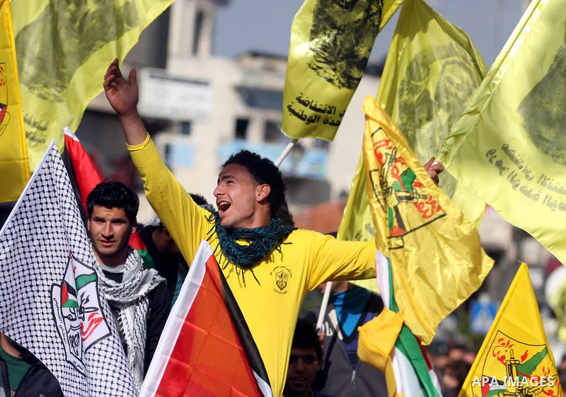 Palestinians hold up Palestinian flags and yellow Fatah flags during a celebration to mark the 47th anniversary of the Fatah political movement, in the West Bank city of Ramallah, Wednesday, Jan. 4, 2012. Photo by Issam...