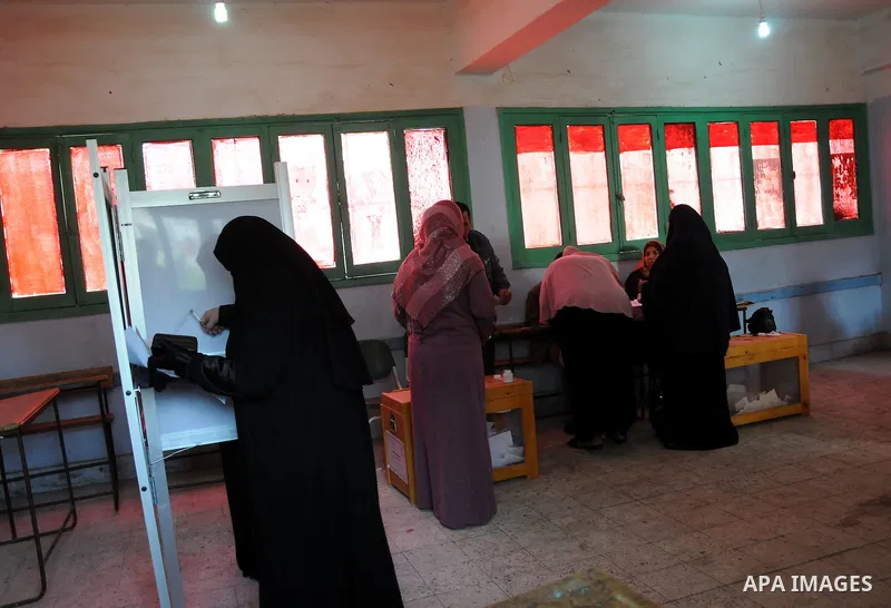 An Egyptian woman votes at a polling center during the second day of the third round of the elections for Egypt's parliament, in Qalyobeia, Egypt Wednesday, Jan. 4, 2012. Egyptians are voting in the final round of electi...