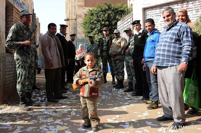 Egyptians, stand amongst army soldiers as they wait to vote at a polling center during the second day of the third round of the elections for Egypt's parliament, in Qalyobeia, Egypt, Wednesday, Jan. 4, 2012. Egyptians ar...