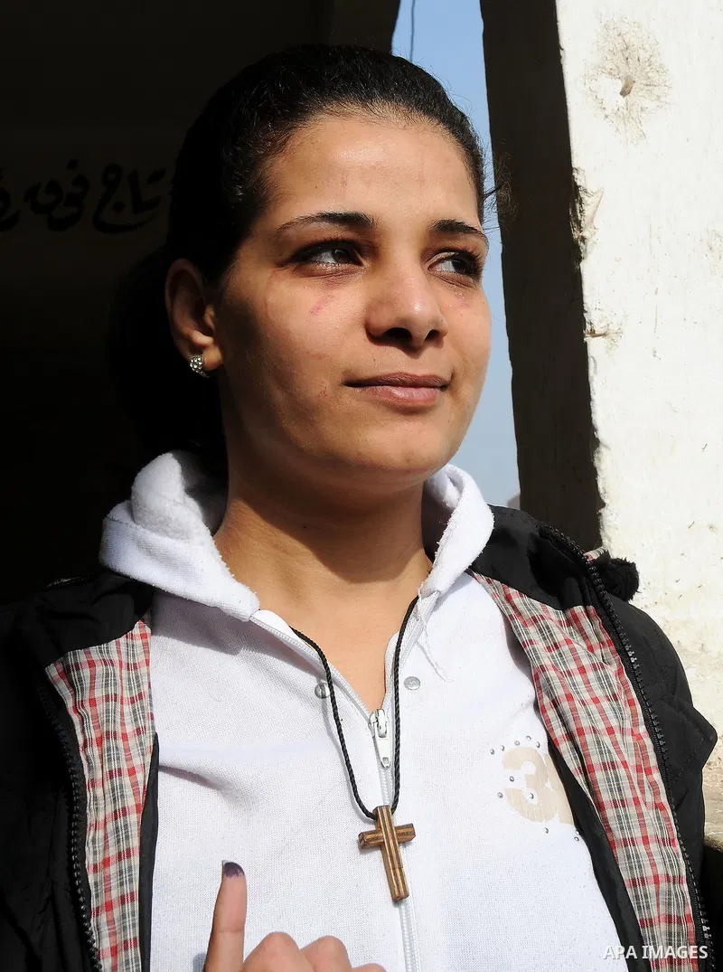 An Egyptian Christian votes at a polling center during the second day of the third round of the elections for Egypt's parliament, in Qalyobeia, Egypt Wednesday, Jan. 4, 2012. Egyptians are voting in the final round of el...