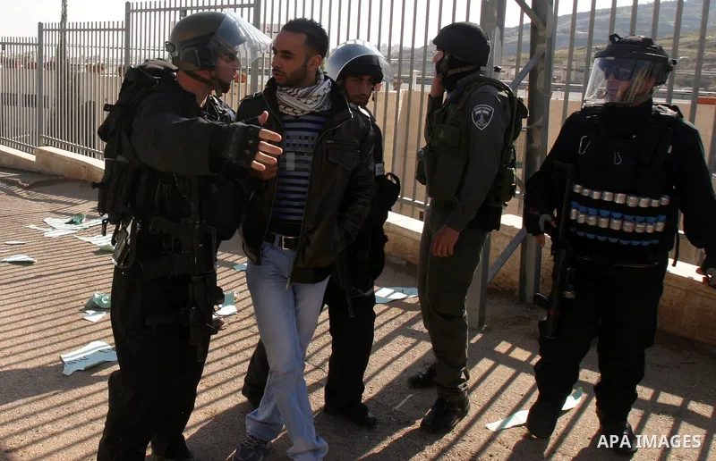 Israeli police officers detain a Palestinian youth during scuffles following the visit of Jerusalem Mayor Nir Barkat, not pictured, in the Issawiya neighborhood in east Jerusalem, Wednesday, Jan. 4, 2012. Minor clashes e...