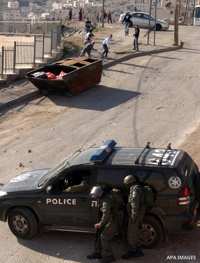 Israeli police officers clashes with Palestinian youths during the visit of Jerusalem Mayor Nir Barkat, not pictured, in the Issawiya neighborhood in east Jerusalem, Wednesday, Jan. 4, 2012. Minor clashes erupted Wednesd...