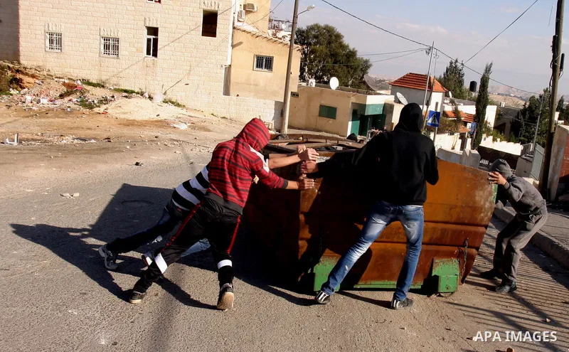 Israeli police officers clashes with Palestinian youths during the visit of Jerusalem Mayor Nir Barkat, not pictured, in the Issawiya neighborhood in east Jerusalem, Wednesday, Jan. 4, 2012. Minor clashes erupted Wednesd...