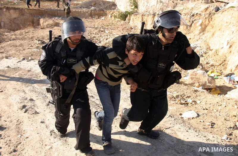 Israeli police officers detain a Palestinian youth during scuffles following the visit of Jerusalem Mayor Nir Barkat, not pictured, in the Issawiya neighborhood in east Jerusalem, Wednesday, Jan. 4, 2012. Minor clashes e...