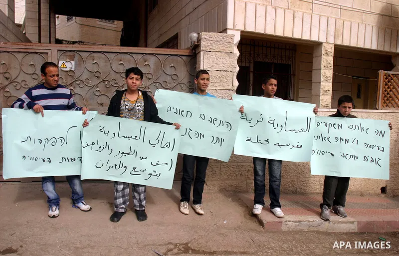 Palestinian youths Protest against the visit of Jerusalem Mayor Nir Barkat, not pictured, in the Issawiya neighborhood in east Jerusalem, Wednesday, Jan. 4, 2012. Minor clashes erupted Wednesday after Jerusalem Mayor Nir...