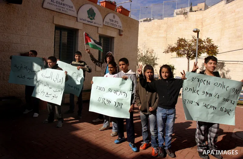 Palestinian youths Protest against the visit of Jerusalem Mayor Nir Barkat, not pictured, in the Issawiya neighborhood in east Jerusalem, Wednesday, Jan. 4, 2012. Minor clashes erupted Wednesday after Jerusalem Mayor Nir...