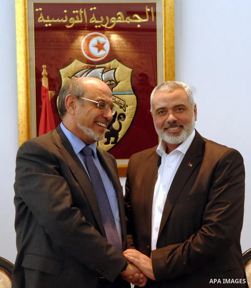 Tunisia's Prime Minister Hamadi Jbeli (R) speaks with senior Palestinian prime minister in gaza strip, Ismail Haniyeh, in Tunis January 5, 2012. Photo by Mohammed Al-Ostaz