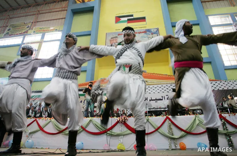 Palestinians celebrate during a mass wedding organized by the Fatah movement for around 40 released Palestinian prisoners in Rafah refugee camp in the southern Gaza Strip on January 5, 2012. Photo by Abed Rahim Khatib