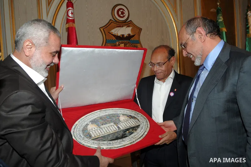 Tunisian President Moncef Marzouk receives from Gaza's Prime Minister, Ismail Haniya a miniature of Al-Quds mosque on January 5, 2012 at Carthage Palace in Tunis. Photo by Mohammed Al-Ostaz