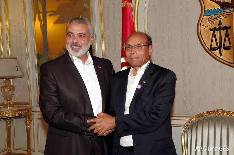 Tunisian President Moncef Marzouki (R) greets Gaza's prime minister Ismail Haniya (L) on January 5, 2012 in Carthage Palace inTunis. Haniya is on two-day official visit to Tunisia. Photo by Mohammed Al-Ostaz