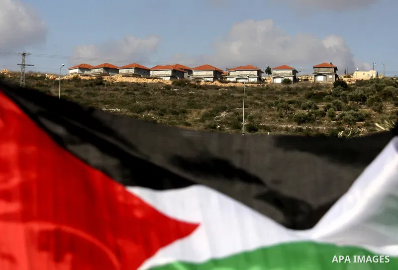 Palestinian and Activists run away from tear gas during a protest against the expansion of the nearby Jewish settlement of Halamish in the West Bank village of Kafer qadum, near Nablus, Friday, Jan. 6, 2012. Photo by Wag...