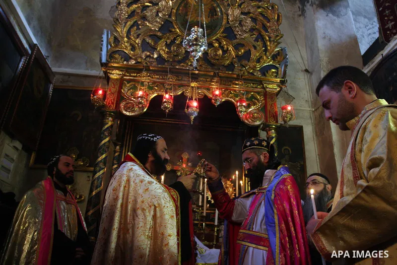 Greek Orthodox priests attend the Christmas procession inside the Church of the Nativity in the West Bank town of Bethlehem January 6, 2012. Photo by Issam Rimawi
