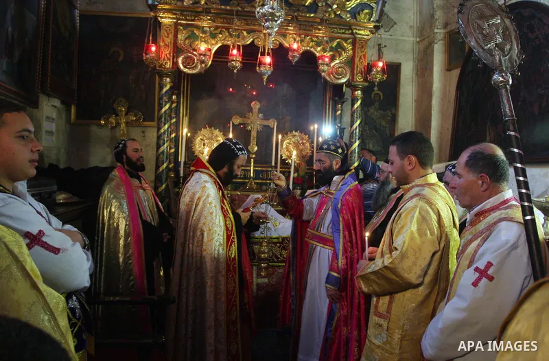 Greek Orthodox priests attend the Christmas procession inside the Church of the Nativity in the West Bank town of Bethlehem January 6, 2012. Photo by Issam Rimawi