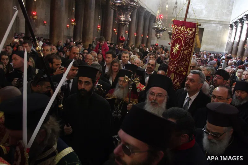 Greek orthodox priests prepare for the arrival of the Greek Orthodox Patriarch of Jerusalem Metropolitan Theophilos and the start of the Christmas procession inside the Church of the Nativity in the West Bank town of Bet...