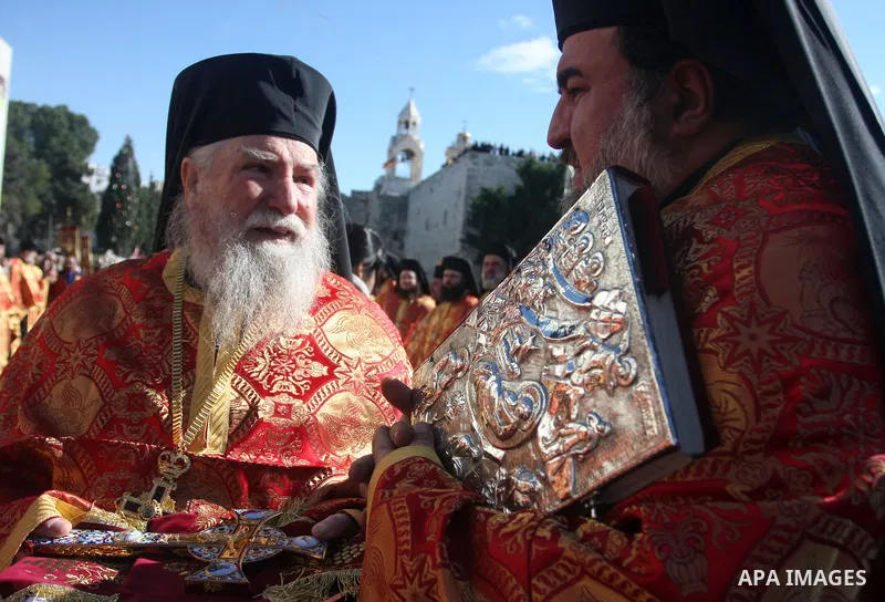 Greek Orthodox priests attend the Christmas procession inside the Church of the Nativity in the West Bank town of Bethlehem January 6, 2012. Photo by Issam Rimawi