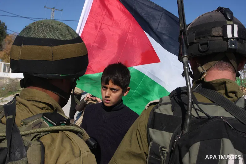 Israeli soldiers stand face-to-face with Palestinian during a demonstration against Israel's controversial separation barrier in the village of Maasarah, near the biblical West Bank city of Bethlehem, Friday, Jan. 6, 201...
