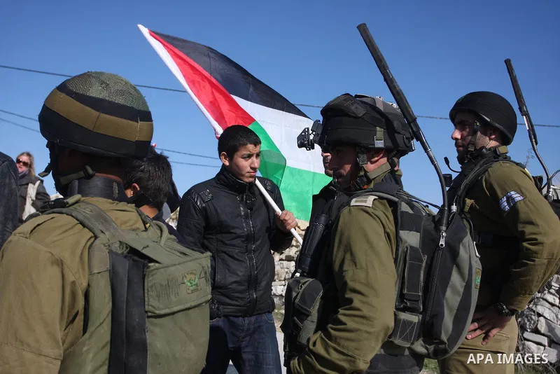 Israeli soldiers stand face-to-face with Palestinian during a demonstration against Israel's controversial separation barrier in the village of Maasarah, near the biblical West Bank city of Bethlehem, Friday, Jan. 6, 201...