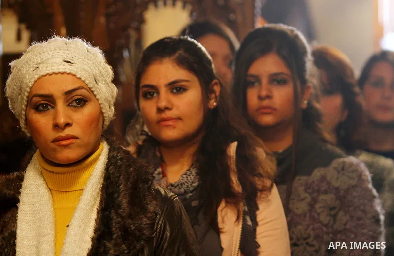 Palestinian Greek Orthodox Christians attend Christmas mass at the Orthodox Saint Porfirios church in Gaza City on January 7, 2012. The Orthodox Church celebrates Christmas and other religious holidays according to the J...