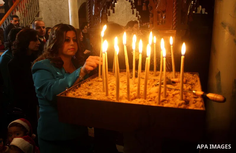 Palestinian Greek Orthodox Christians attend Christmas mass at the Orthodox Saint Porfirios church in Gaza City on January 7, 2012. The Orthodox Church celebrates Christmas and other religious holidays according to the J...