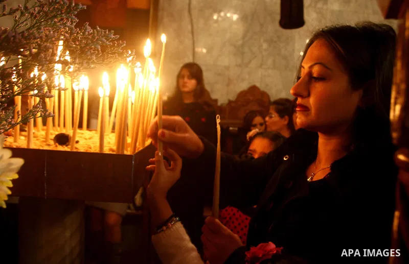 Palestinian Greek Orthodox Christians attend Christmas mass at the Orthodox Saint Porfirios church in Gaza City on January 7, 2012. The Orthodox Church celebrates Christmas and other religious holidays according to the J...