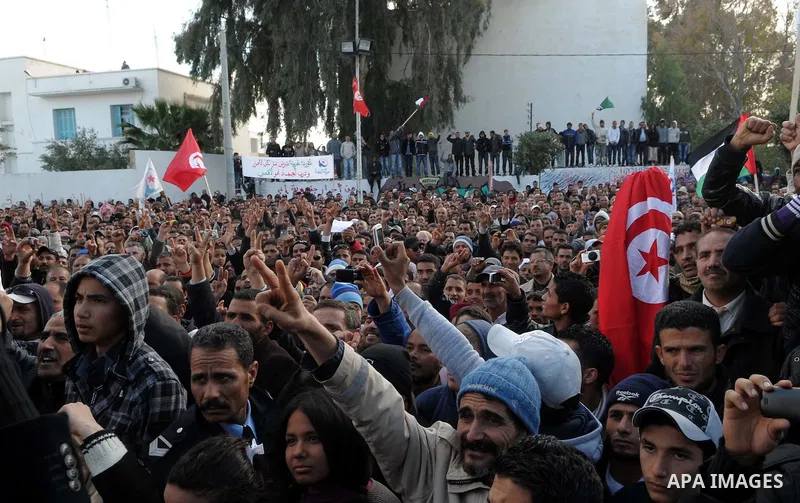 Tunisian Islamist Ennahdha Party supporters cheer as they greet of Palestinian Prime Minister in gaza strip, Ismail Haniya on January 7, 2012 in Tunis. Photo by Mohammed Al-Ostaz